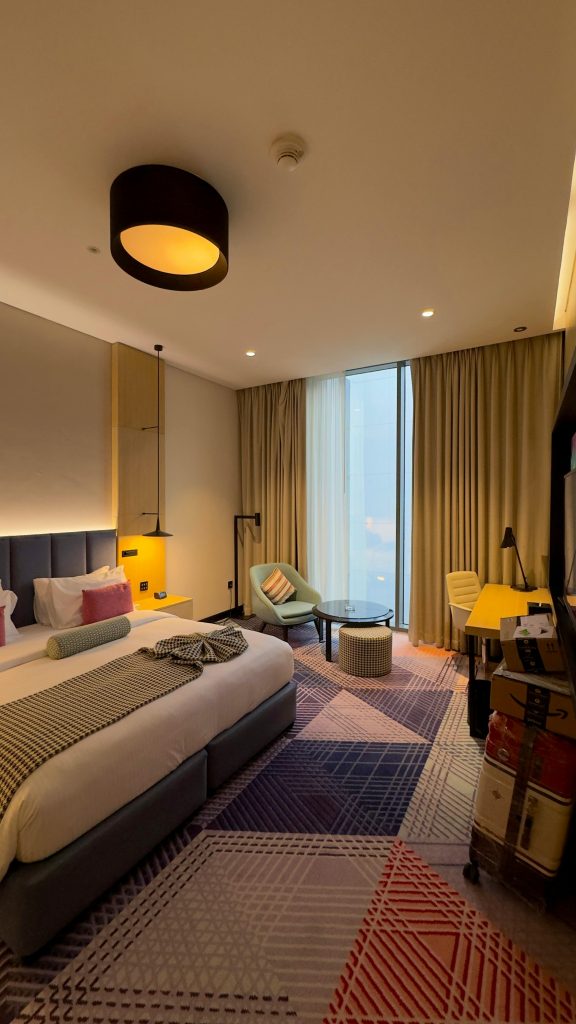 Elegant and spacious hotel room in Hyderabad with modern decor and designer furniture.